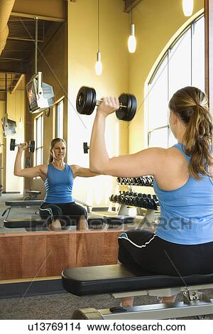 Woman Seated Lifting Weights View Large Photo Image Picture - Woman Seated Lifting Weights. Fotosearch