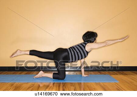 Stock Image - Woman Stretching in Yoga Pose. Fotosearch