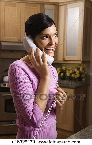 Woman talking on phone View Large Photo Image Stock Photo - Woman talking on phone. Fotosearch