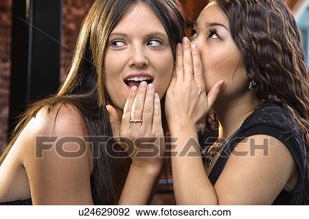 Stock Image - Woman telling secrets. Fotosearch