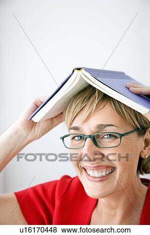 Stock Photo - Woman with book on her head. Fotosearch
