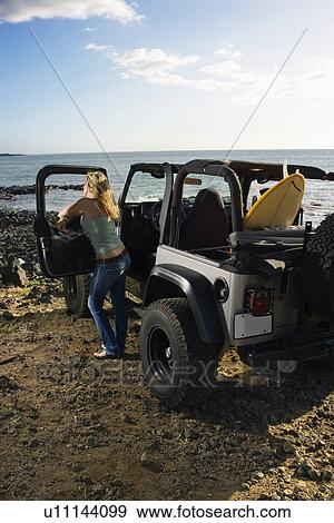 Stock Photo - Woman with SUV at the Beach. Fotosearch