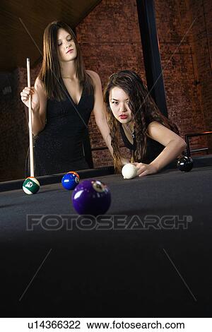 Stock Image - Women playing pool. Fotosearch
