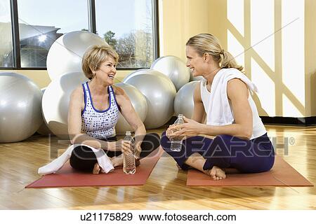 Stock Photo - Women Sitting and Socializing at Gym. Fotosearch