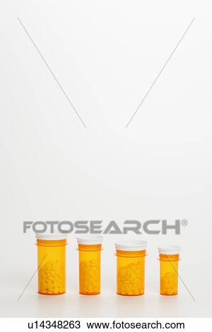 Stock Image - Yellow Medicine Bottles With Pills. Fotosearch
