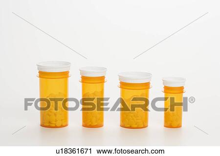 Stock Image - Yellow Medicine Bottles With Pills. Fotosearch