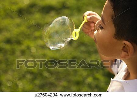 Picture - Young Boy Blowing Bubbles. Fotosearch