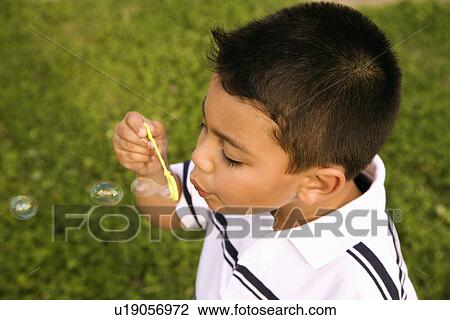 Young Boy Blowing Bubbles View Large Photo Image Stock Image - Young Boy Blowing Bubbles. Fotosearch
