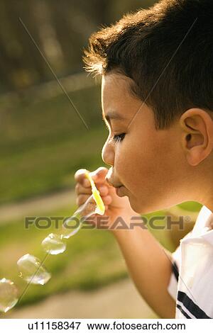 Young Boy Blowing Bubbles View Large Photo Image Stock Photo - Young Boy Blowing Bubbles. Fotosearch