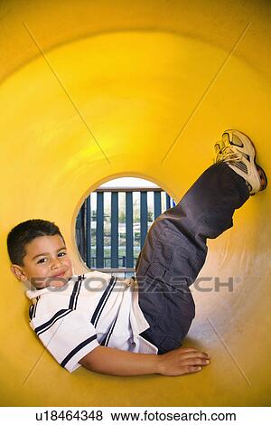 Stock Photo - Young Boy Lying in Crawl Tube. Fotosearch