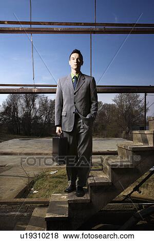 Young Businessman Standing on Stairs View Large Photo Image Stock Photo - Young Businessman Standing on Stairs. Fotosearch