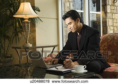 Young Businessman using Laptop View Large Photo Image Stock Photo - Young Businessman using Laptop. Fotosearch