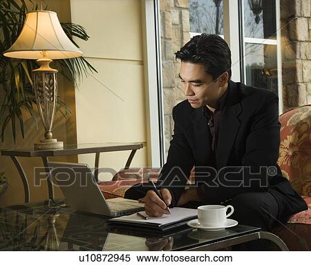Stock Photography - Young Businessman using Laptop. Fotosearch