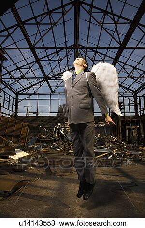 Stock Image - Young Businessman With Angel Wings. Fotosearch