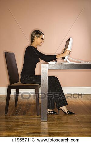Stock Image - Young Businesswoman Looking at Computer Surprised. Fotosearch
