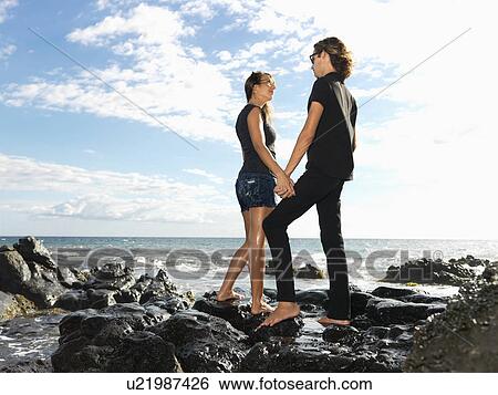 Young Couple on Rocks View Large Photo Image Stock Photograph - Young Couple on Rocks. Fotosearch