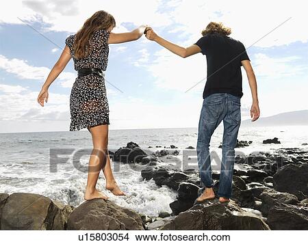 Picture - Young Couple Walking at Beach. Fotosearch
