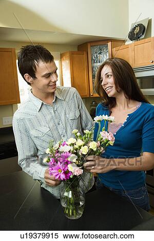 Stock Photography - Young couple with flowers. Fotosearch