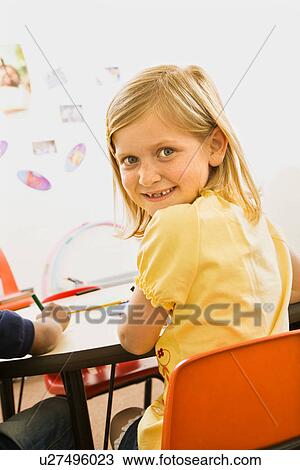 Stock Image - Young Girl in Classroom. Fotosearch