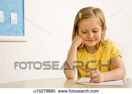 Young Girl Smiling in Classroom Writing on Paper View Large Photo Image Stock Photography - Young Girl Smiling in Classroom Writing on Paper. Fotosearch