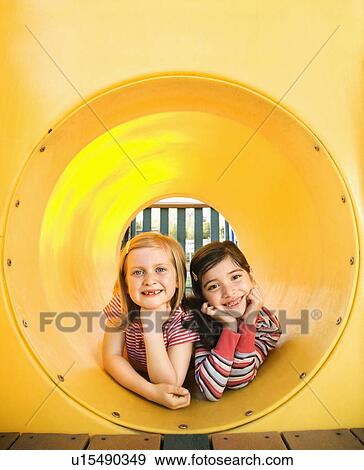 Stock Photo - Young Girls Lying Together in Crawl Tube. Fotosearch