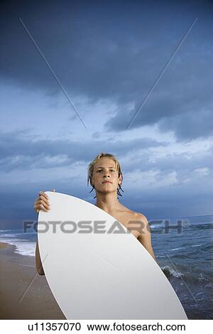 Stock Image - Young male surfer. Fotosearch