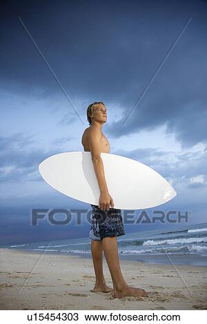 Stock Image - Young male surfer. Fotosearch