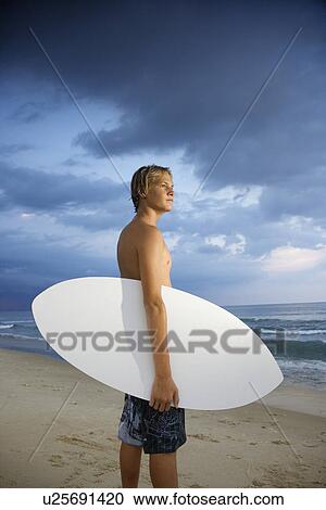 Young male surfer View Large Photo Image Stock Image - Young male surfer. Fotosearch