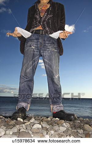 Picture - Young Man at Beach with Empty Pockets. Fotosearch