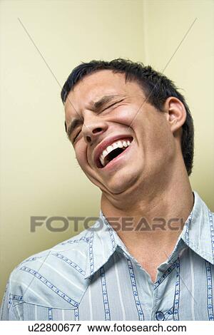 Young man laughing View Large Photo Image Stock Photo - Young man laughing. Fotosearch