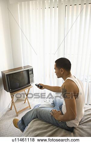 Young Man Turning on TV View Large Photo Image Stock Photo - Young Man Turning on TV. Fotosearch