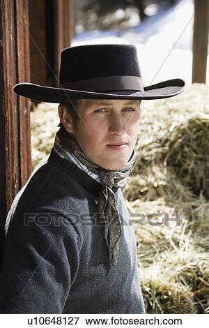 Young Man Wearing a Black Cowboy Hat View Large Photo Image Stock Photo - Young Man Wearing a Black Cowboy Hat. Fotosearch
