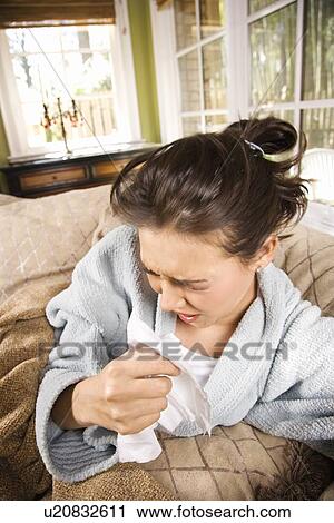 Stock Image - Young Sick Woman Sneezing. Fotosearch