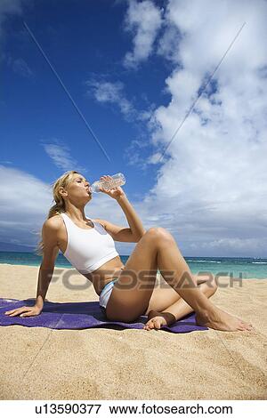 Young Woman Drinking on Beach View Large Photo Image Stock Photo - Young Woman Drinking on Beach. Fotosearch