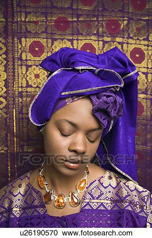 Stock Image - Young Woman in Traditional African Dress With Eyes Closed. Fotosearch