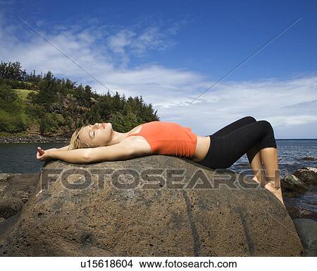 Young Woman Lying on Rock at Beach View Large Photo Image Picture - Young Woman Lying on Rock at Beach. Fotosearch