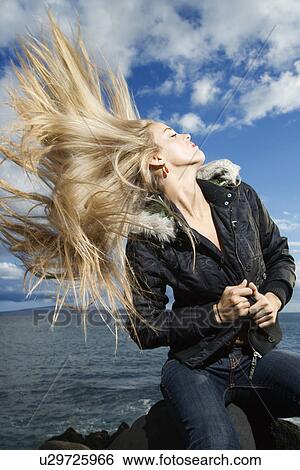 Young Woman Tossing Blond Hair View Large Photo Image Stock Photograph - Young Woman Tossing Blond Hair. Fotosearch