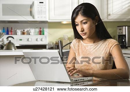 Stock Image - Young Woman Using Laptop. Fotosearch