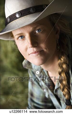 Picture - Young Woman Wearing a Cowboy Hat. Fotosearch