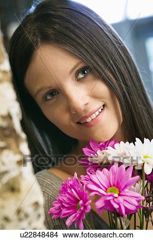 Young woman with flowers View Large Photo Image Picture - Young woman with flowers. Fotosearch