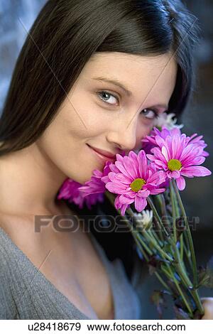 Stock Photo - Young woman with flowers. Fotosearch