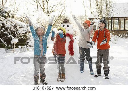 Children Building Snowman In Garden View Large Photo Image Stock Photo - Children Building Snowman In Garden. Fotosearch