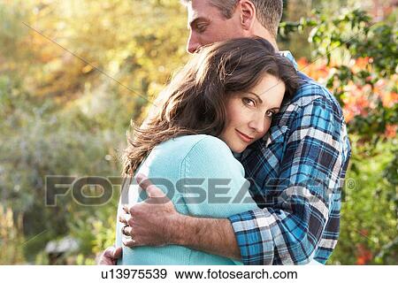 Close Up Of Romantic Couple Embracing By Autumn Woodland View Large Photo Image Stock Photo - Close Up Of Romantic Couple Embracing By Autumn Woodland. Fotosearch