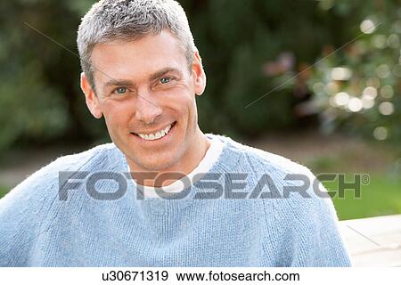 Stock Photo - Close Up Portrait Of Man Standing Outside In Autumn Landscape. Fotosearch