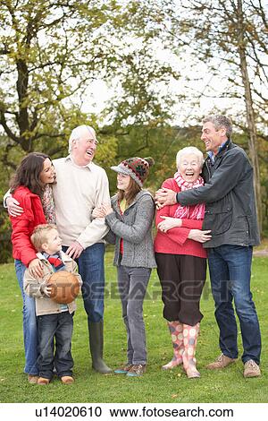 Stock Image - Extended Family Group On Walk Through Countryside. Fotosearch