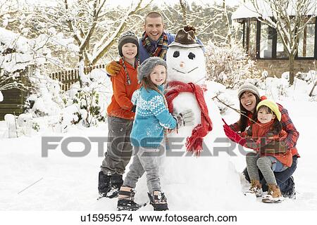 Family Building Snowman In Garden View Large Photo Image Picture - Family Building Snowman In Garden. Fotosearch