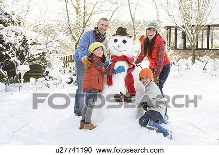 Family Building Snowman In Garden View Large Photo Image Stock Image - Family Building Snowman In Garden. Fotosearch