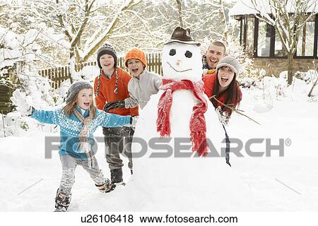 Family Building Snowman In Garden View Large Photo Image Stock Photo - Family Building Snowman In Garden. Fotosearch