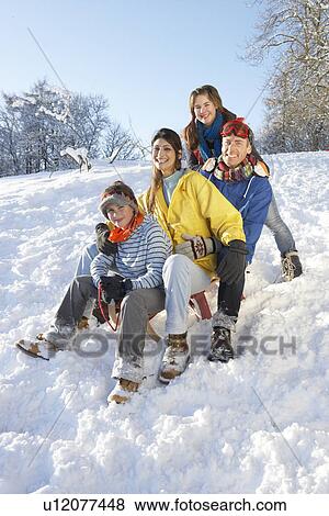 Family Enjoying Sledging Down Snowy Hill View Large Photo Image Stock Photo - Family Enjoying Sledging Down Snowy Hill. Fotosearch