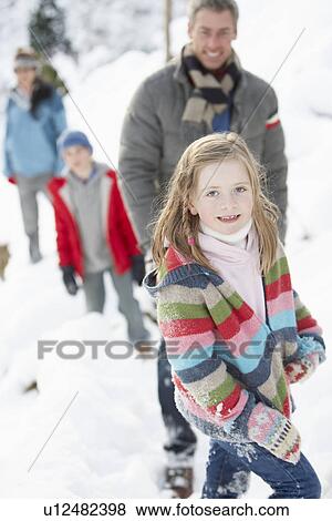 Family Enjoying Walk Through Snowy Landscape View Large Photo Image Stock Photo - Family Enjoying Walk Through Snowy Landscape. Fotosearch